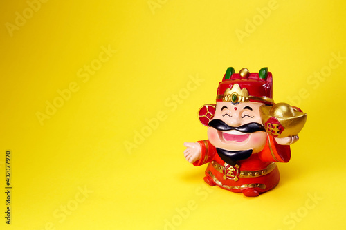 God of wealth holding gold ingot  Chinese text translation  gold and wealth