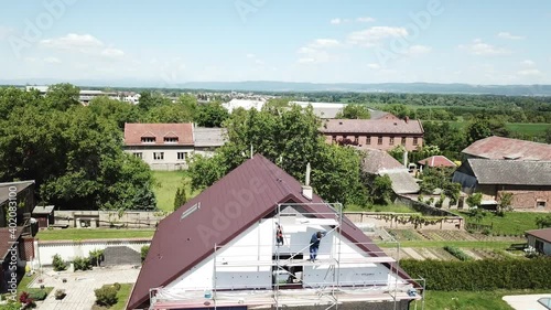Workers to renovate a house. Aerial shot of thermal insulation of the facade of a family house.
