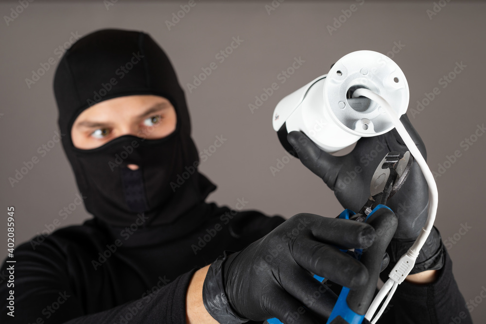 Thief turning off surveillance camera