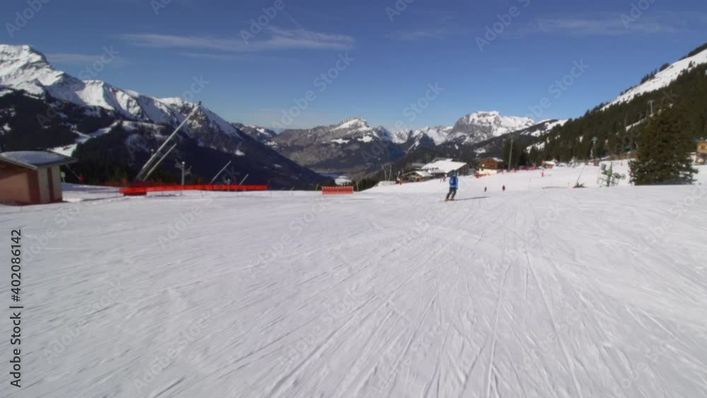Professional advanced skier skiing on slopes in the Swiss alps Professional advanced skier skiing on slopes in the Swiss alps