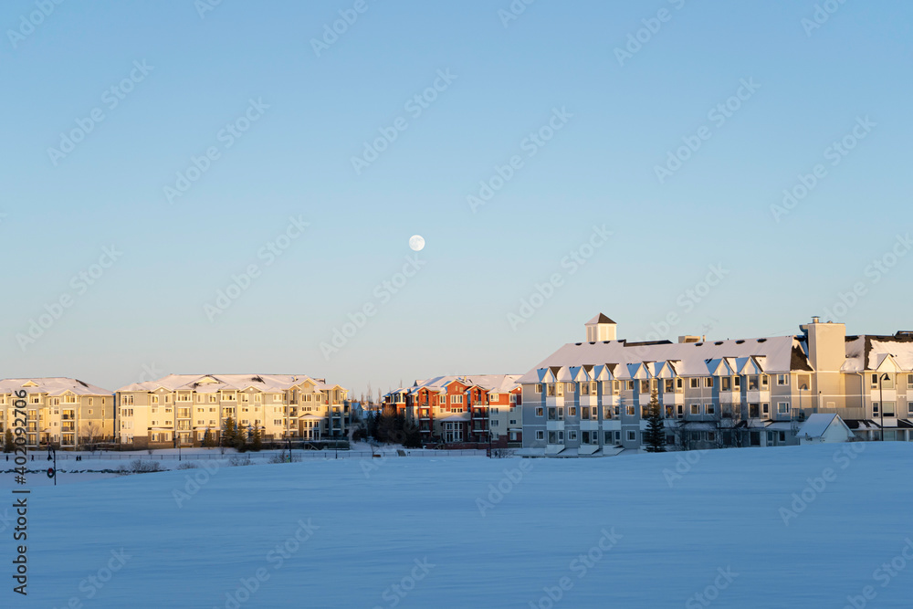 Residential Apartment blocks with frozen lake in foreground in winter