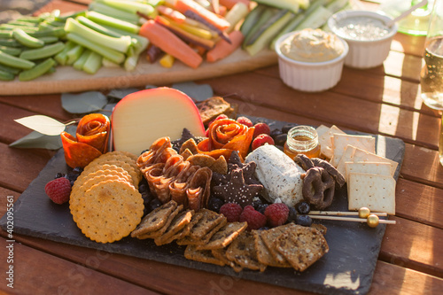 Table set with a grazing board and various appetizers including crudites and dips. Gourmet tapas presentation. Horizontal orientation. 