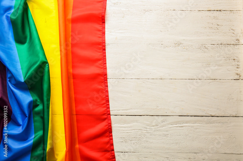 Rainbow LGBT flag on wooden background