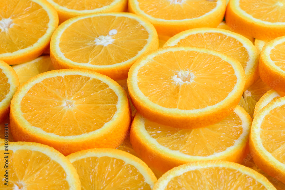 Texture of sliced orange, fresh and healthy fruit, which is rich in juice and vitamin c. Orange background. Texture of sliced orange, fresh and healthy fruit, which is rich in juice and vitamin c. Orange background.