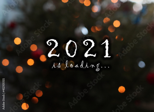 writing 2021 is loading on festival blurring background with lights