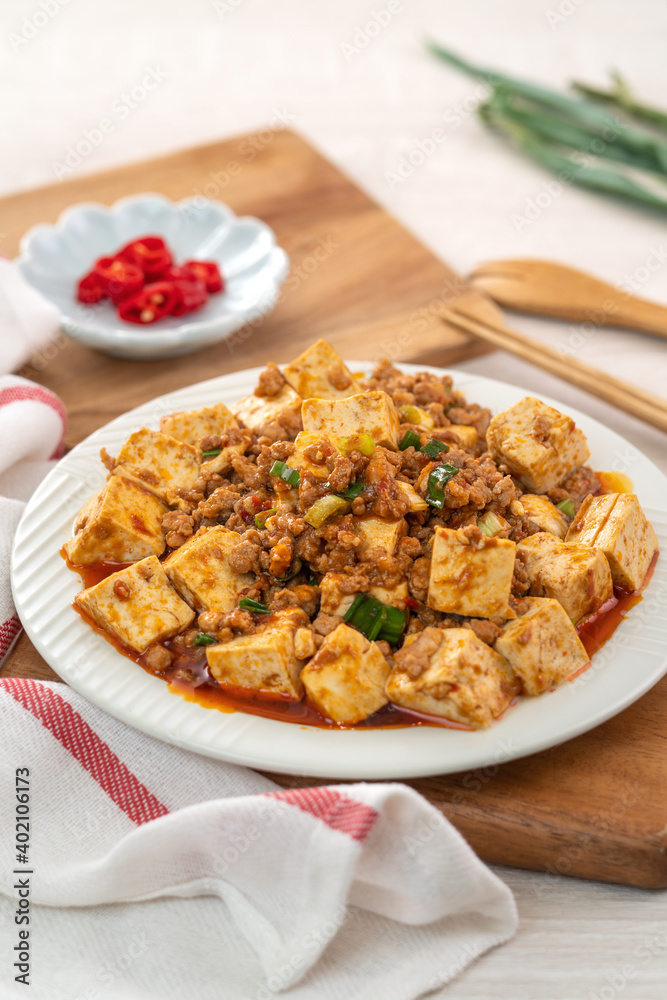 Mapo tofu, stir-fried tofu with hot spicy sauce in white plate.