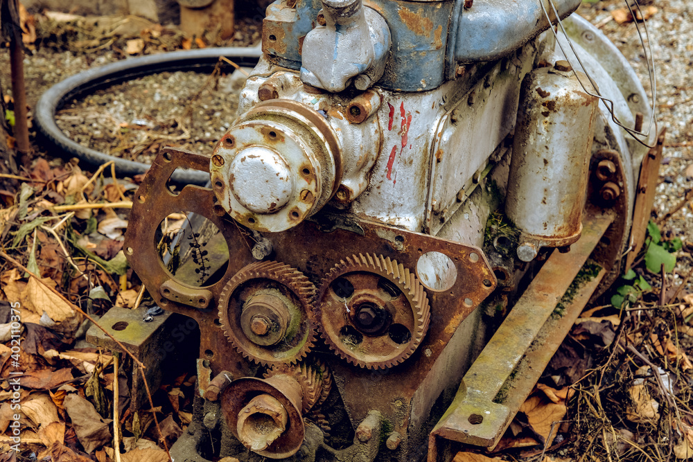 Outdoor scenery with abandoned car engine on the ground Outdoor scenery with abandoned car engine on the ground