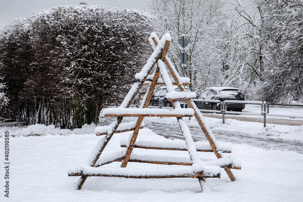 Empty wooden frame for haystack covered with snow in winter. Urban design object on rural country theme Empty wooden frame for haystack covered with snow in winter. Urban design object on rural country theme