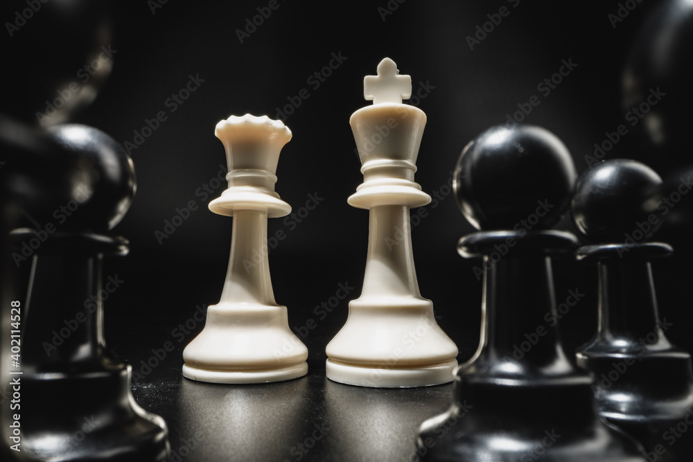 Chess game with chess pieces against black background