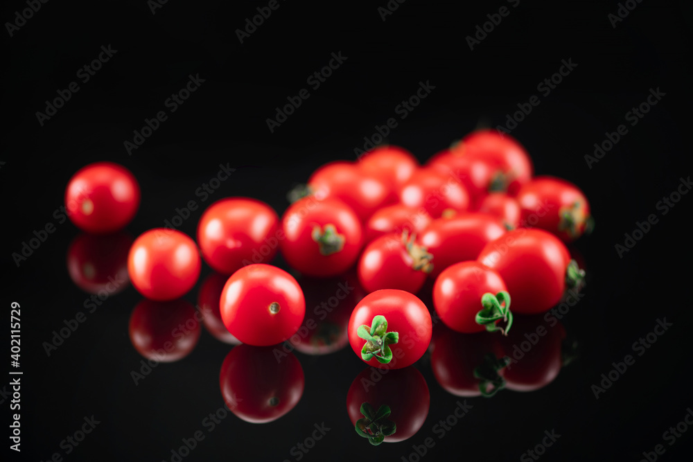 Cherry Tomato on a Black Reflective Background