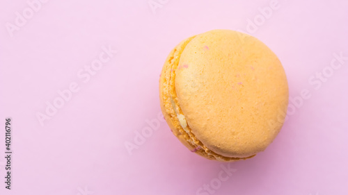 French cake macaron on pink background. Tasty fruit, almond sweet cookie