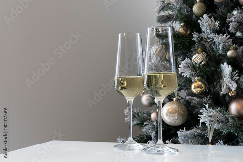 Christmas holiday table with two glasses of champagne. Eve of new year, preparation and laying of a holiday table.