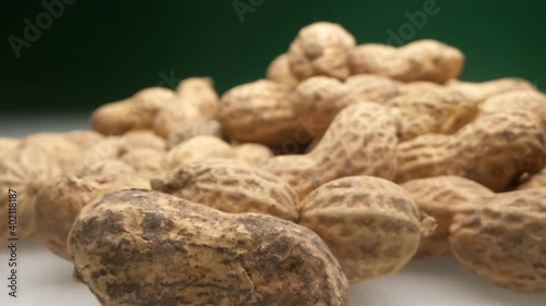 extremely close-up, detailed. peanuts in shells on a dark background.