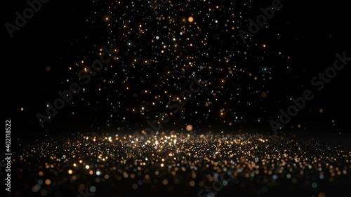 Glittering golden particles falling from the sky against a dark background.