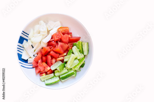 Top down view of fresh cut vegetable on the plate isolate on white background