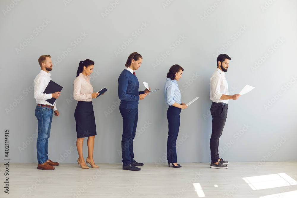 Obraz premium Job seekers applicants for vacancy standing in line with resumes and waiting for interview