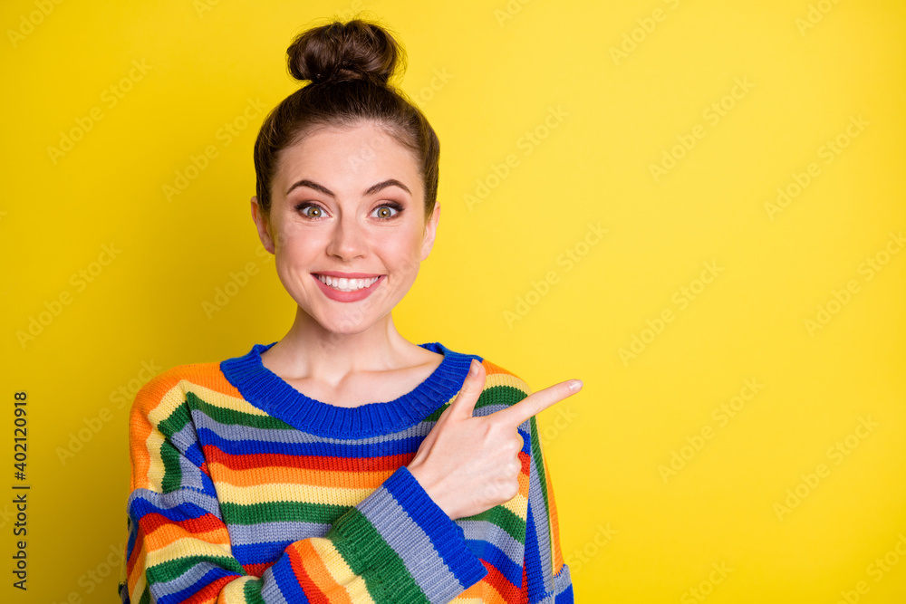 Photo of young attractive positive smile girl show point index finger empty space promo advert isolated over yellow color background Photo of young attractive positive smile girl show point index finger empty space promo advert isolated over yellow color background