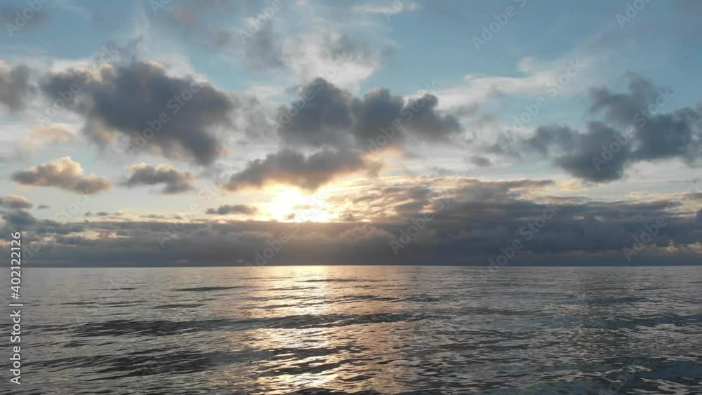 Flight in fantastic sky over silky sea awesome sundown aerial view with golden horizon with wall clouds and cirrus Flight in fantastic sky over silky sea awesome sundown aerial view with golden horizon with wall clouds and cirrus