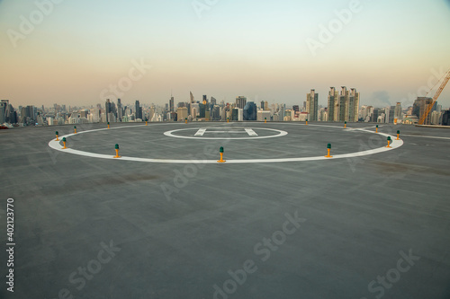  Heli Copter parking lot on the deck at sunset in the capital of Thailand. Space for helicopter landing on high-rise buildings in Bangkok, Thailand.