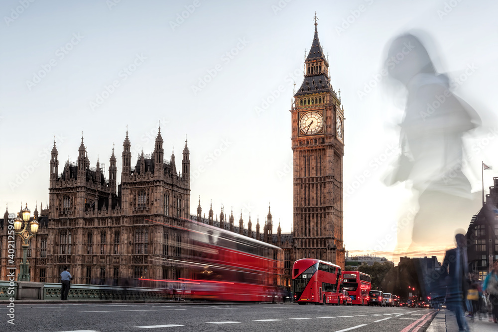 Big Ben with red buses on the bridge in the evening, London, England, United Kingdom
