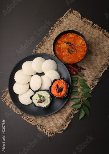 Idly sambar or Idli with Sambhar and green, red chutney. Popular South indian breakfast photo