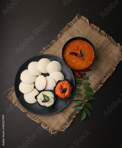 Idly sambar or Idli with Sambhar and green, red chutney. Popular South indian breakfast