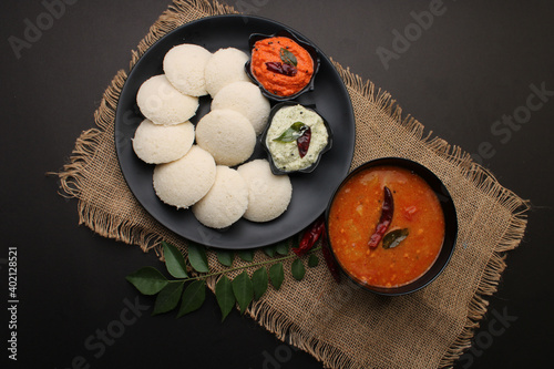 Idly sambar or Idli with Sambhar and green, red chutney. Popular South indian breakfast