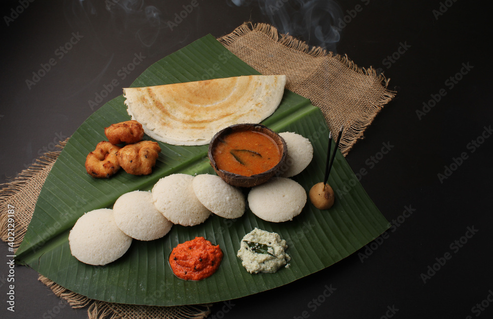 Group of South Indian food like Masala Dosa, Idli, Wada or vada, sambar