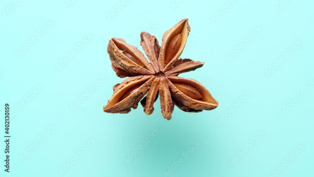 Top view of star anise rotating on blue cyan background with soft shadow. 4k Top view of star anise rotating on blue cyan background with soft shadow. 4k