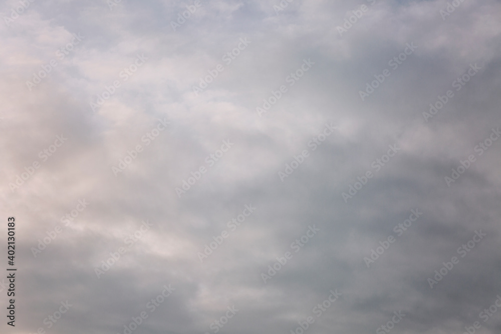 Fototapeta premium Beautiful blue dramatic sky with clouds at sunrise. Background. Space for text.
