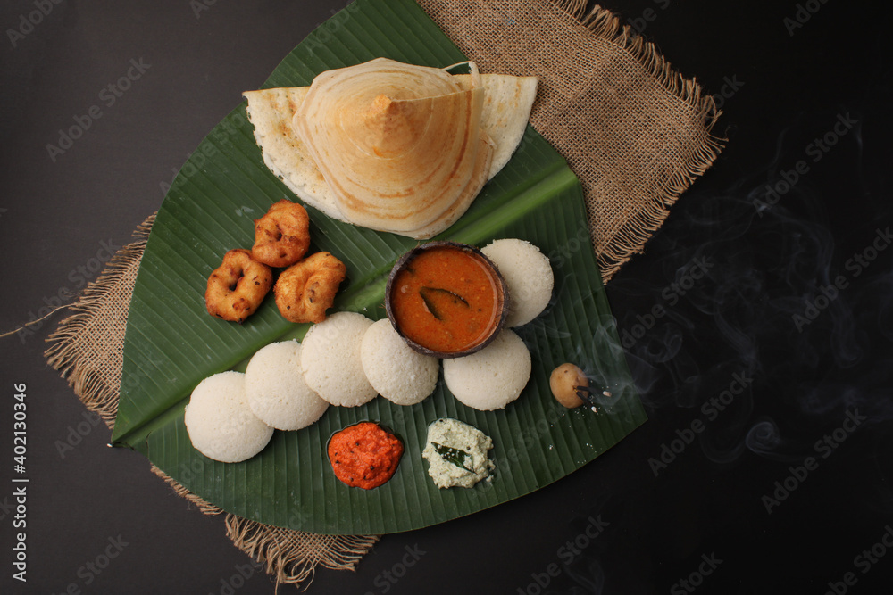 Group of South Indian food like Masala Dosa, Idli, Wada or vada, sambar