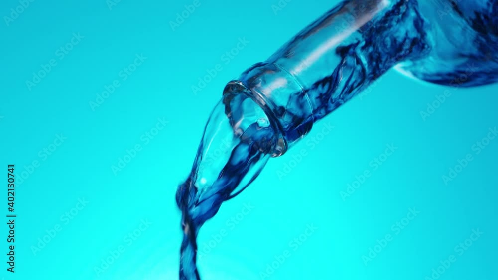 Purple liquid pouring from the bottle throat on blue background while camera is slightly moving. Slow motion, full HD Purple liquid pouring from the bottle throat on blue background while camera is slightly moving. Slow motion, full HD