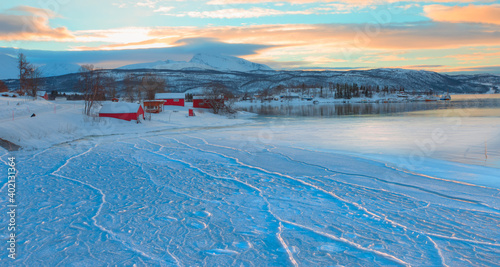 Fotografi Panoramic view at fjord with coast of the Norwegian sea in the background snowy
