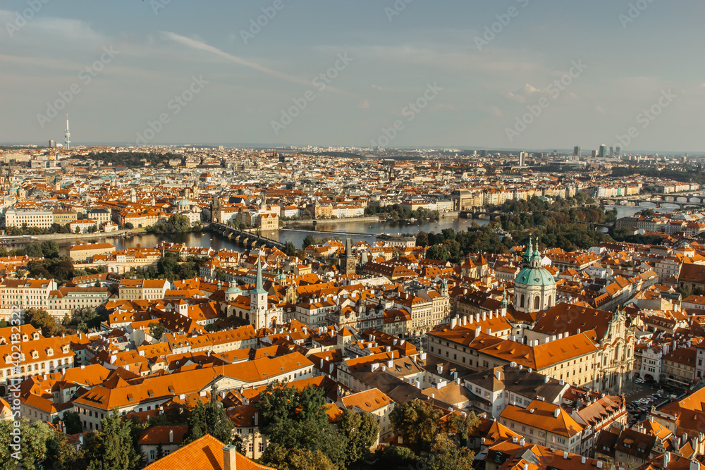 Aerial postcard view of Prague,Czechia. Prague panorama.Beautiful sunny landscape of the capital of Czechia.Amazing European cityscape.Red roofs,bridges over Vltava river,TV tower.Travel scenery