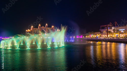 Night view to the Palm Fountain Show, located at the The Pointe Palm Jumeirah in front of Luxurious Atlantis. Hotel taken at the blue hour.