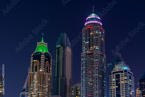 Night view to iconic skyscrapers panorama of Dubai Marina. Amazing illumination of the buildings. Close-up shot at blue hour. photo