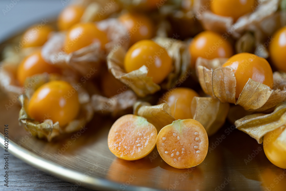 Top view pile of cape gooseberry fruit  in the gold plate.