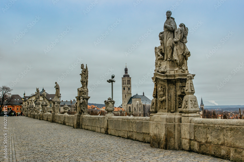 Statues in front of Jesuit College, St James church in background, Kutna Hora,Czech Republic. Travel and architecture background.UNESCO world heritage site.Czech popular tourist attraction. 