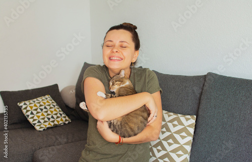 Girl holding a cat in her arms