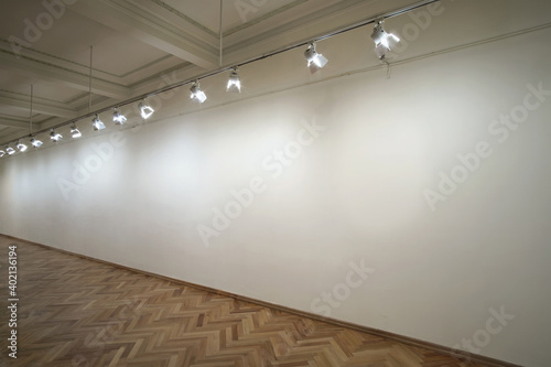 Interior of a empty white wall in perspective with spot lights at art gallery photo