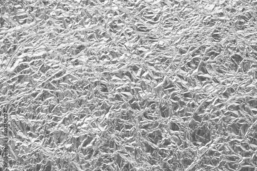 Shiny silver leaf gray foil texture background.