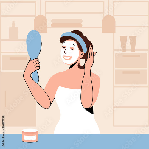 Face care at home. Woman with mirror in her hand doing homemade facial mask