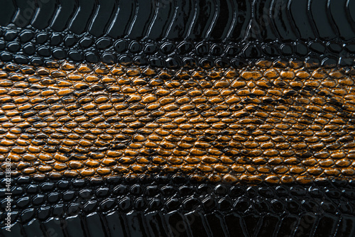 Close up of black snake texture. Dark reptile skin background.