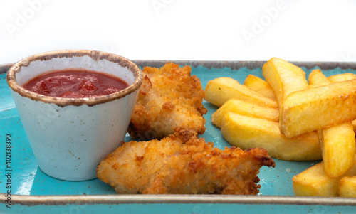 A plate of chicken nuggets with french fries photo