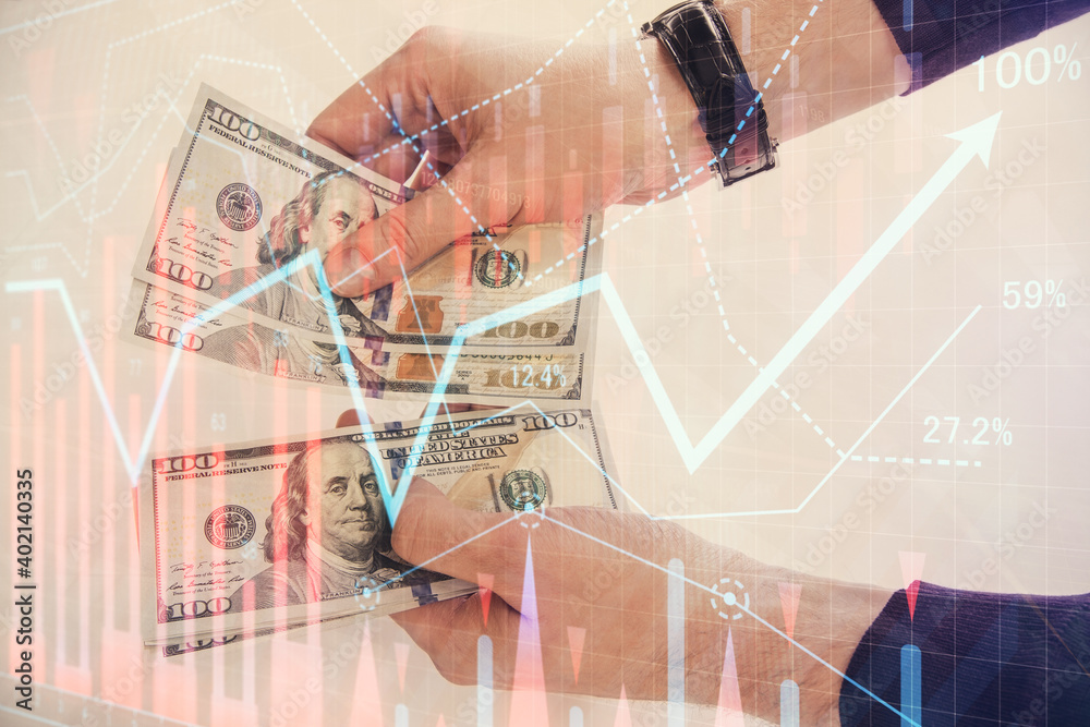 Multi exposure of financial graph drawing hologram and USA dollars bills and man hands. Analysis concept. Multi exposure of financial graph drawing hologram and USA dollars bills and man hands. Analysis concept.