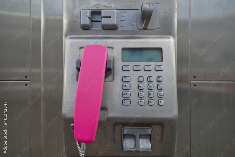 Close-up detail of phone and metal keypad inside public Telephone booth in Europe. Close-up detail of phone and metal keypad inside public Telephone booth in Europe.
