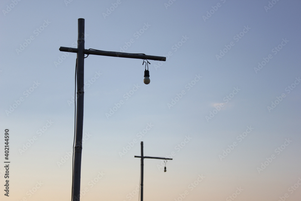 Wooden light pole at sunset