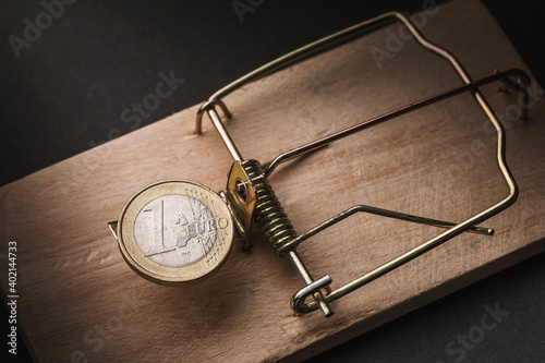 One euro in a mousetrap. Financial trap concept photo