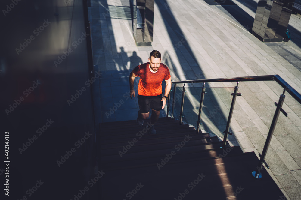 Young sportsman going upstairs during training Young sportsman going upstairs during training