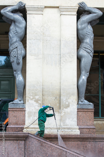 A worker washes the portico of the new Hermitage. City services wash the portico with Atlanteans photo